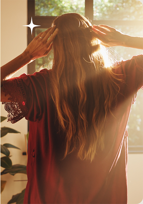 Woman listening to NuCalm in warm sunlight